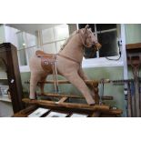 A WOODEN FRAMED PLUSH ROCKING HORSE bearing the label "Mamas & Papas"