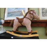 A CORDUROY ROCKING HORSE ON BEECH FRAME