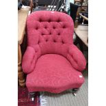 A RE-UPHOLSTERED VICTORIAN BUTTON BACK DEEP SEATED ARMCHAIR on turned show wood legs with white