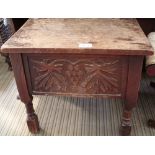 A CARVED OAK FOUR LEGGED BOX TOP STOOL