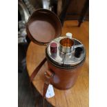 A LEATHER CASED MULTI-BOTTLE FLASK with tumbler cups