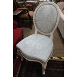 A WHITE PAINTED WOODEN FRAMED FRENCH DESIGN CHAIR with upholstered back and seat pad, with