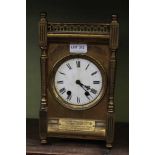 A LATE 19TH / EARLY 20TH CENTURY BRASS CASED MANTEL CLOCK with presentation plaque