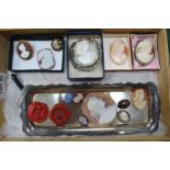 A BOX CONTAINING A SELECTION OF CARVED CAMEOS, wax seals and a probable Whitby Jet brooch