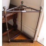 AN EARLY 20TH CENTURY BRASS & IRON CORNER STICK STAND