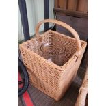 A WOVEN WICKER BASKET CONTAINING A LARGE GLASS VASE & SEASHELLS VARIOUS