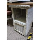 A LLOYD LOOM BEDSIDE UNIT with single cupboard door