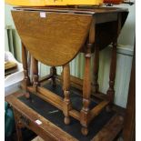 A SMALL SIZED OAK TWIN FLAP GATELEG TABLE on plain turned and block legs