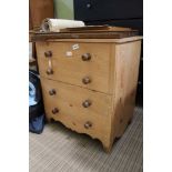 A LATE 19TH CENTURY PINE BOX COMODE IN THE FORM OF A CHEST OF FOUR DRAWERS