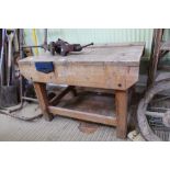 A CHILD'S SIZED SOFTWOOD WORK BENCH together with a metal bench vice
