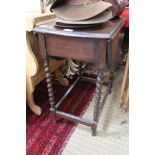 AN OAK FINISHED SMALL SIZED TWIN FLAP TABLE with barley twist legs