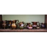 A SHELF FULL OF 19TH CENTURY COPPER LUSTRE JUGS