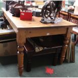 A LARGE PINE RECTANGULAR TOPPED COUNTRY KITCHEN TABLE supported on four turned tapering legs, 77.5cm