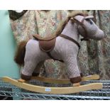 A CORDUROY ROCKING HORSE ON BEECH FRAME