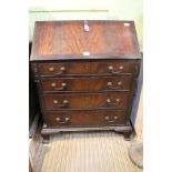 A REPRODUCTION BUREAU WITH MAHOGANY FINISH with well fitted interior