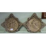 A PAIR OF GILT PAINTED CAST METAL PLAQUES depicting courtship scenes
