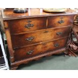 A WALNUT FINISHED FOUR DRAWER CHEST on stubby cabriole legs