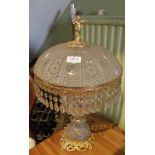 A CUT GLASS & GILT METAL TABLE LAMP having cast figural finial, and faceted pear shaped drop fringe