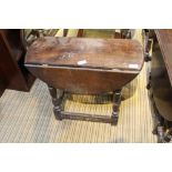 AN OAK FINISHED TWIN FLAP COFFEE TABLE on turned & block legs