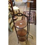 A WROUGHT IRON FREESTANDING CANDLESTICK together with a mahogany three tier folding cake stand