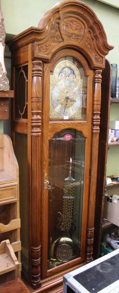 A LARGE OAK FRAMED LONGCASE CLOCK by Howard Miller of Michigan, having a Kieninger movement, with