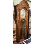 A LARGE OAK FRAMED LONGCASE CLOCK by Howard Miller of Michigan, having a Kieninger movement, with