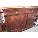 A MAHOGANY SIDE UNIT having plain rectangular top, with two inline drawers, over two carved panelled