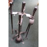 A WROUGHT IRON COMPANION STAND containing three matching utensils plus an extra toasting fork