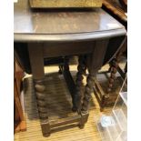 A DARK FINISHED TWIN FLAP GATELEG TABLE on barley twist uprights