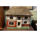 A FIRST QUARTER 20TH CENTURY DOLLS HOUSE together with a large selection of furnishings