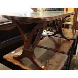 A REPRODUCTION MAHOGANY RECTANGULAR TOPPED COFFEE TABLE with tooled skiver insert top, supported