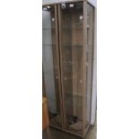 A MODERN FREESTANDING THREE QUARTER GLAZED DISPLAY UNIT, front door opening to reveal adjustable