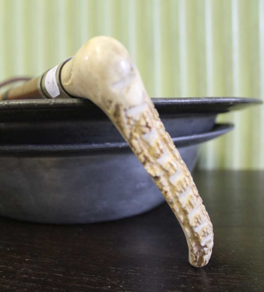 A PLAITED LEATHER WHIP with horn handle, together with two antique pewter dishes - Image 2 of 2