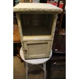 A WHITE PAINTED LLOYD LOOM BEDSIDE UNIT together with a similar circular topped table