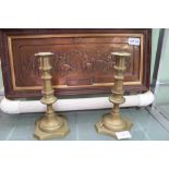 A PAIR OF BRASS CANDLESTICKS, together with a pressed 3D plaque depicting the Canterbury Pilgrims