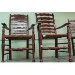 A HARLEQUIN SET OF RUSH SEATED LADDER BACK CHAIRS comprising six singles and two carvers