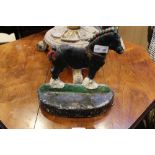 A PAINTED METAL DOORSTOP in the form of a Shire Horse