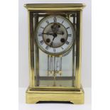 SAMUEL MARTI A BRASS FOUR-GLASS MANTEL CLOCK, white enamel dial with Roman numerals, recessed centre