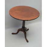 A 19TH CENTURY MAHOGANY CIRCULAR TILT TOP TABLE, on canon barrel turned column and three downswept