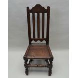 AN 18TH CENTURY SINGLE CHAIR, having plain slat back over solid seat, turned and block fore legs