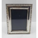 A LATE 20TH CENTURY SILVER PHOTOGRAPH FRAME having bound reeded border, easel back, London assay,