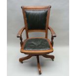 AN EARLY 20TH CENTURY MAHOGANY FRAMED ADJUSTABLE GENTLEMAN'S DESK CHAIR, with padded back and