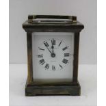 A FRENCH CARRIAGE CLOCK, the brass case with bevelled glass panels, movement by R & Cie made in