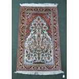 A PERSIAN DESIGN SILK RUG, central mihrab with blossoming tree & birds design, cream ground,