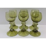 A SET OF SIX GERMAN GLASS ROEHMERS, green tinted with raspberry prunts around the tops of the