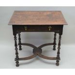 A JACOBEAN OAK SIDE TABLE, the moulded edge plank top over a frieze drawer and scroll carved rail,
