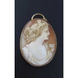 A CARVED SHELL CAMEO PENDANT, profile portrait of a young woman in classical taste, Bacchanalian