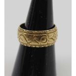 AN 18CT GOLD RING, carved with floral decoration in the round, engraved presentation inscription