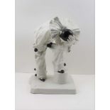A 20TH CENTURY CONTINENTAL POTTERY PIERROT FIGURE modelled in a pose of desperation, 30cm high