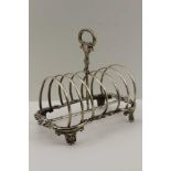 HENRY WILKINSON & CO A MID-19TH CENTURY SILVER TOAST RACK, having floral cast frame, central hoop
